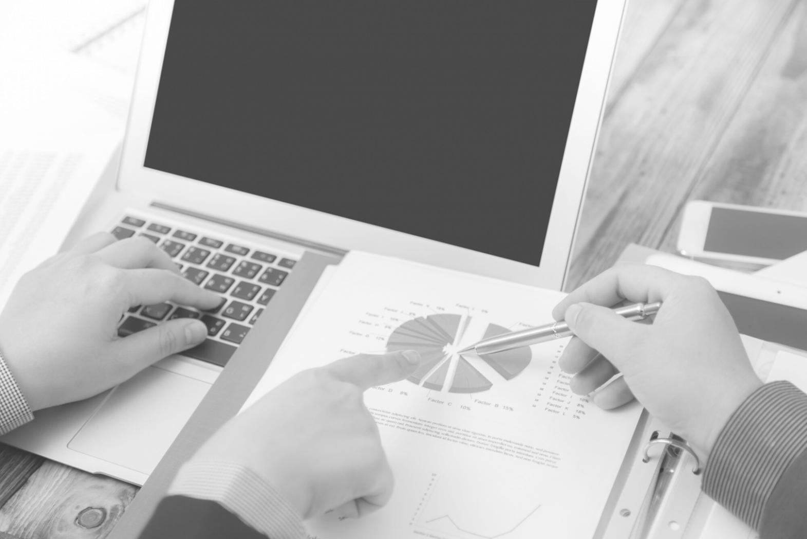 Modern office workspace showing collaborative budget planning environment